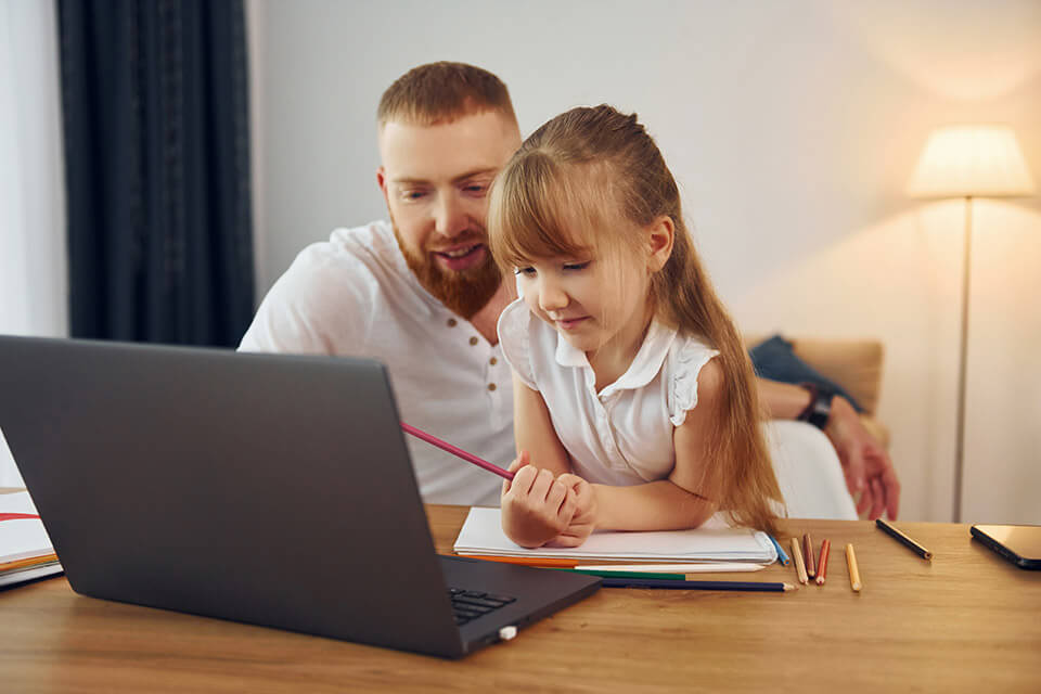 father and daughter looking at computer